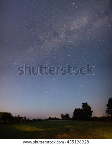 Beautiful milky way galaxy on a night sky and silhouette of tree with cloud, Long exposure photograph.with grain