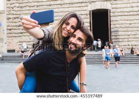 Lovely young couple piggyback in Florence. Italy