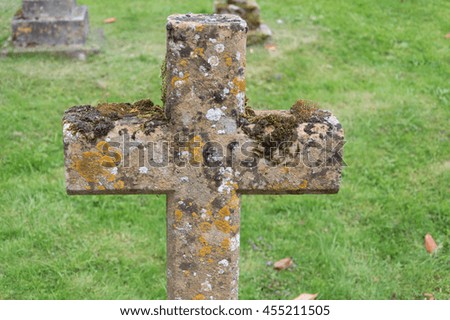 Close up of a stone cross in the churchyard a cloudy day