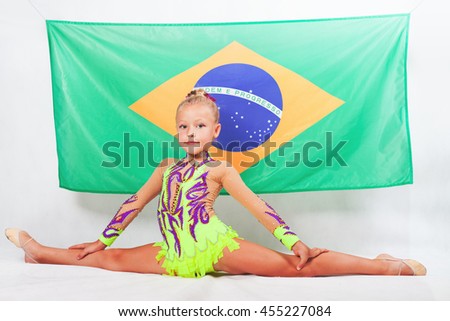 Girl doing artistic gymnastics element, split. Compete in individual events. Balance. Brazilian flag at the white background. Brazil fan support. Gymnastics program