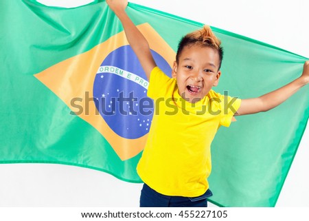 Brazilian patriot and fan boy holding Brazil flag. Football or soccer championship. Support. White background