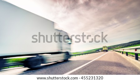 lorry cargo trucks in highway, blur motion Royalty-Free Stock Photo #455231320