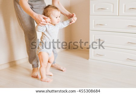 Mother and baby legs. First steps. Royalty-Free Stock Photo #455308684