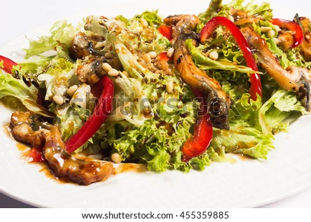 green salad made with sea eel, red peppers and nuts