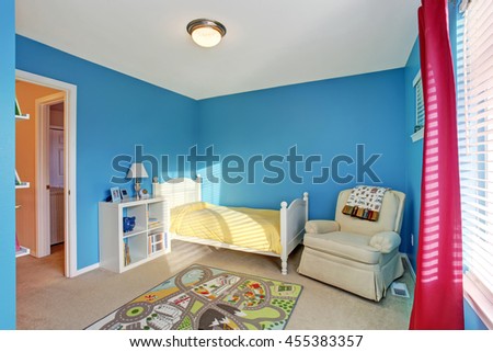 Cute kids room with blue walls, carpet and red curtains