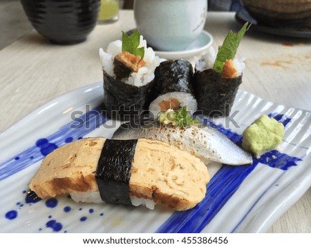 Egg sushi, Sashimi sushi and seaweed sushi serve with wasabi on the plate 