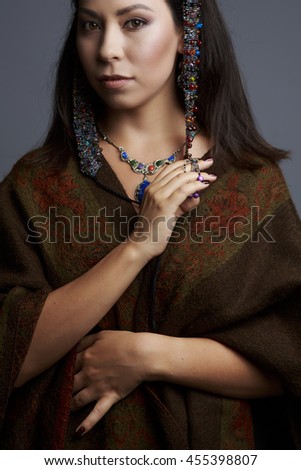 Portrait of a beautiful woman in traditional dress drilled
