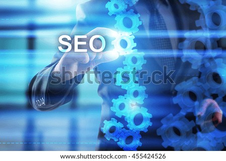 Businessman is selecting SEO on the virtual screen.