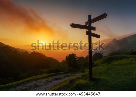 signpost in the mountain at the sunset Royalty-Free Stock Photo #455445847