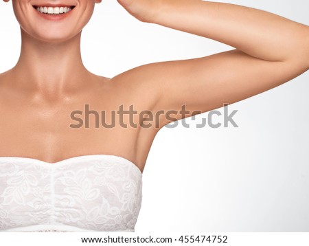 Armpit epilation, lacer hair removal. Young woman holding her arms up and showing clean underarms, depilation smooth clear skin .Beauty portrait. Royalty-Free Stock Photo #455474752