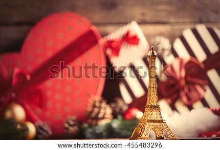 photo of the eiffel tower shaped toy on the christmas decorations background