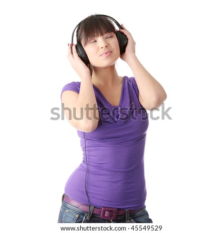 Young beautiful happy women listening music in headphones