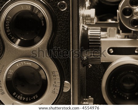 several vintage photographic cameras monochrome sepia image