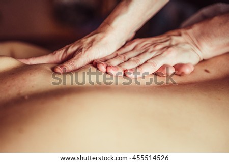 Image of a Masseuse giving a relaxing back massage at a spa