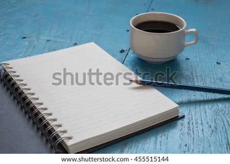 Blank notebook with pencil on table background copy space / selective focus