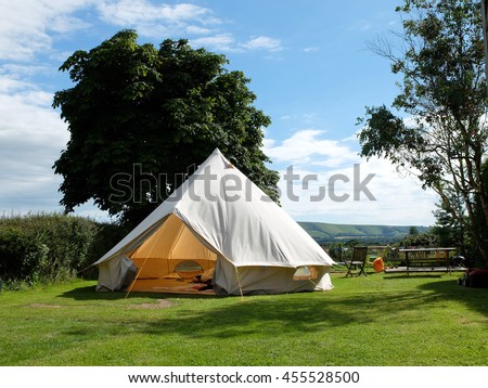Traditional canvas bell tent in english countryside Royalty-Free Stock Photo #455528500