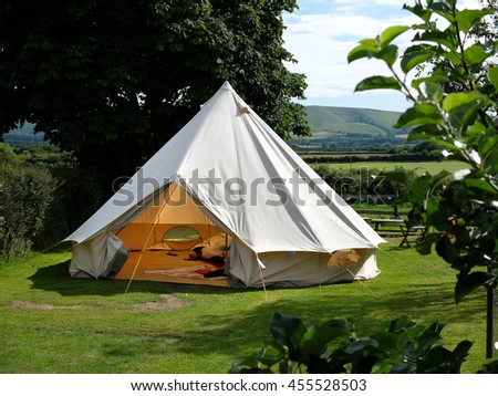 Traditional canvas bell tent in english countryside Royalty-Free Stock Photo #455528503