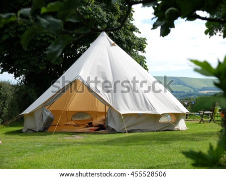 Traditional canvas bell tent in english countryside Royalty-Free Stock Photo #455528506