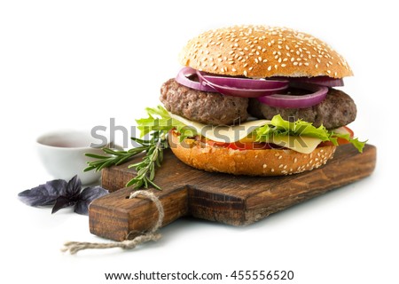 Hamburger with beef meat and fresh vegetables on a wooden board