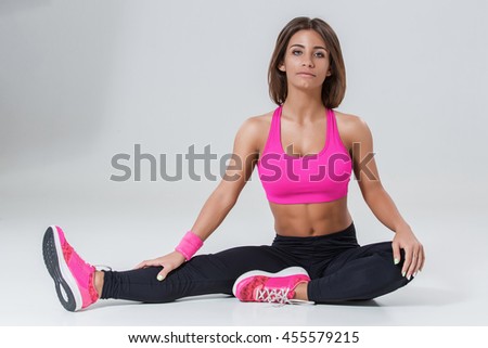 Sporty flexible girl doing stretching exercise