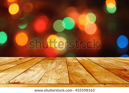 Empty wooden deck table over abstract bokeh light background