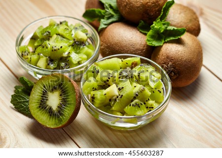 Healthy food. Tropical fruit. Whole and sliced kiwi. Kiwi fruit. Still life. Juicy kiwi on the wooden table Royalty-Free Stock Photo #455603287