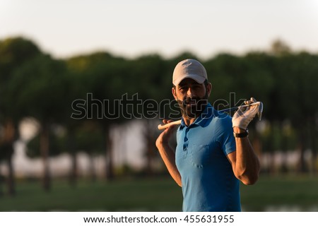 handsome middle eastern golfer portrait at golf course at beautiful sunset