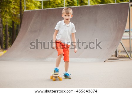 Boy riding on a skateboard on a skate playground 