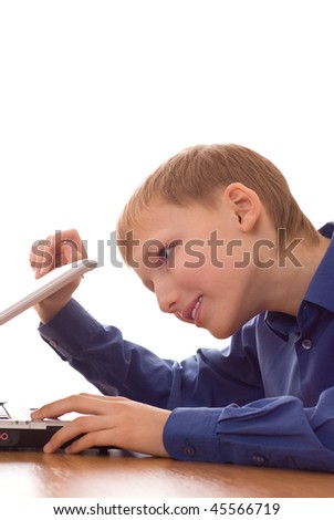 happy boy in the blue shirt looks into the laptop