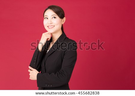 portrait of asian businesswoman isolated on red background