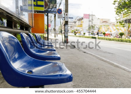 Blue plastic seats in bus stop, soft focus