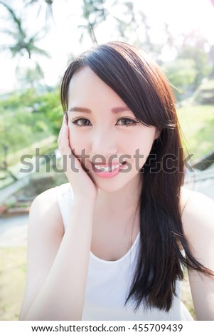 young woman selfie and smile to you with nature green background