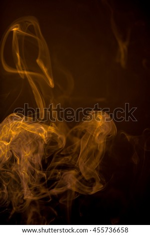 Gold smoke motion on black background.