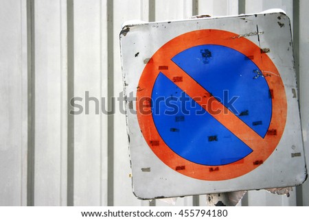 Old no parking sign with galvanized sheet