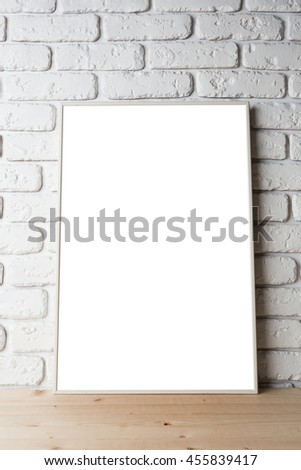 blank black picture frame on the wall