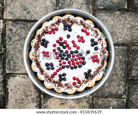 Rounded delicious cake with blueberries and currants in the form. Sweet food theme. International cuisine. Holiday symbol.