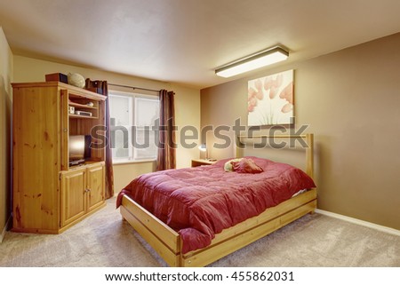 Cozy bedroom with wooden furniture, brown curtains and carpet floor