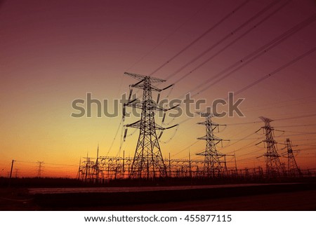 high voltage electric power steel tower in the setting sun, closeup of photo
