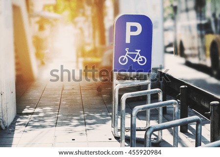 Bicycle parked sign tracks in the city, vintage tone with bright light
