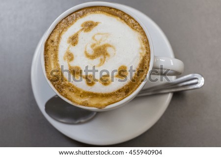 The cup of cappuccino on the table