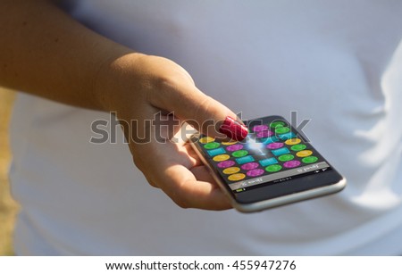 white woman playing with her smartphone. All screen graphics are made up.