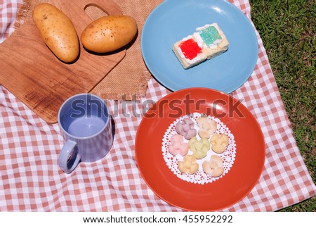Picnic for a summer vacation with potato , snack and cake.