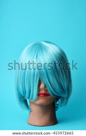 a mannequin head with a blue hair wig on a blue background