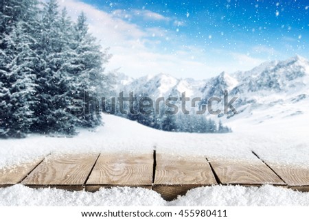 winter blue landscape of alps and wooden old table with snow and frost 