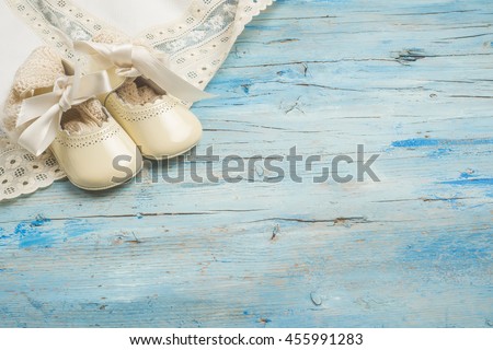 Baby newborn background,  vintage newborn clothes and shoes for baptism on wooden background , blank space for message Royalty-Free Stock Photo #455991283
