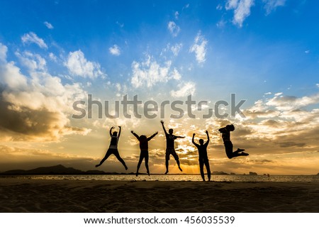 Business Team people jumping retreat together on the beach for happy weekend Family wellness life travel concept for celebrate of good success mlm freedom saving financial support, great friend day Royalty-Free Stock Photo #456035539