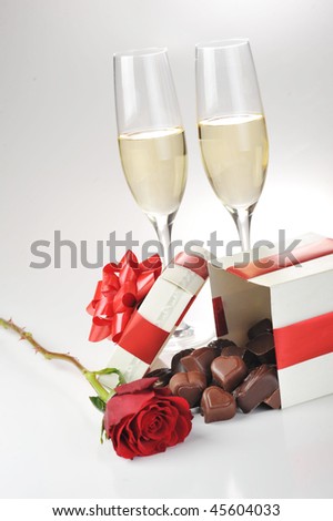 beautiful red rose, champagne  and chocolate  close up