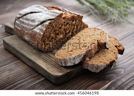Sliced rye bread on cutting board closeup Royalty-Free Stock Photo #456046198