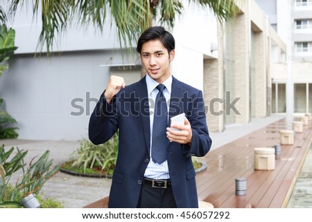 Happy man holding a smart phone 