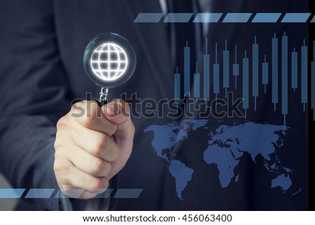 Businessman in suit looking for virtual world using a small magnifier.